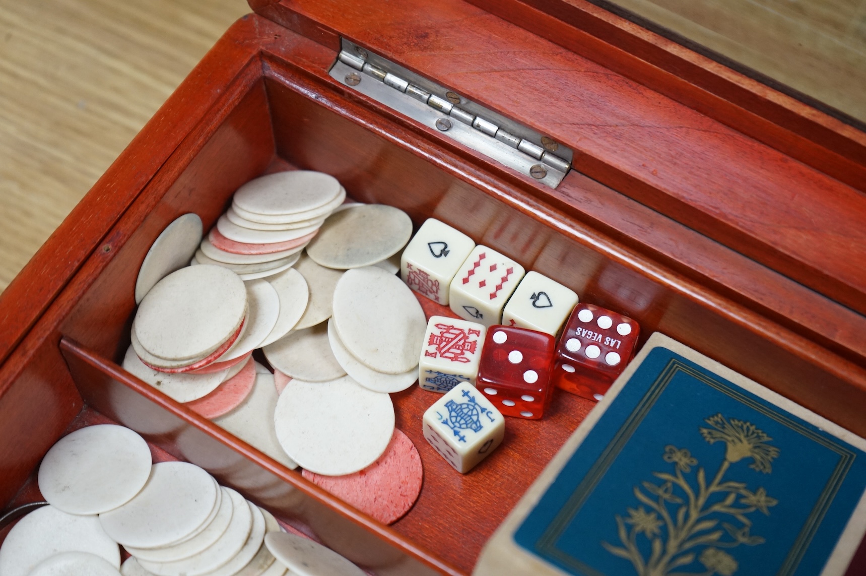 A French stained teak games box with bone counters, various playing cards, etc, 30cm wide